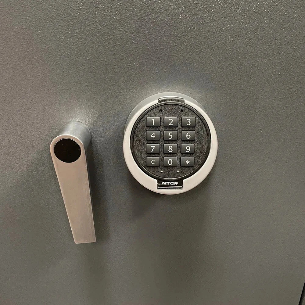 A close-up of the digital keypad and handle on a gray 12 Watch Winder Safe Grade 3 by Aevitas, featuring numbers 0-9 and symbols *, #. The Aevitas name is below the keys, with a £350,000 insurance rating.