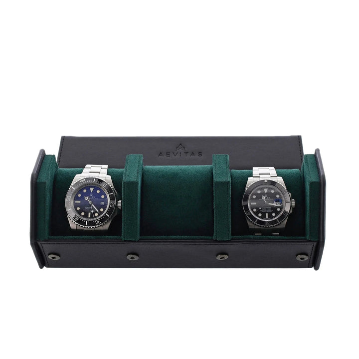 Two silver wristwatches with dark faces sit side by side in an Aevitas Watch Winders 3 Watch Travel Case, featuring black leather and green lining in a hexagon style, each watch secure in its own compartment.