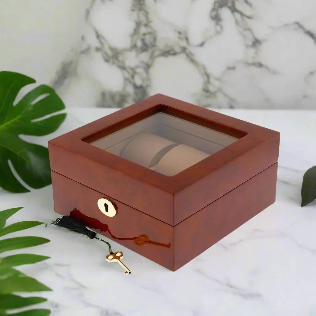 The Aevitas 6 Watch Box in luxurious camphor wood with camel lining features a glass top and key, designed to securely store up to 6 watches.