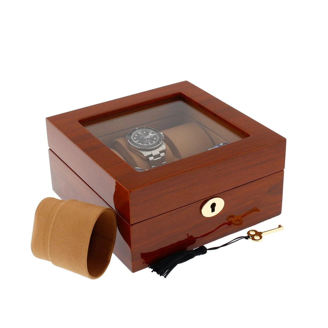 The Aevitas 6 Watch Box in luxurious mahogany wood with camel lining features a glass lid, gold lock, tassel and key, plus a removable watch cushion for elegant display.