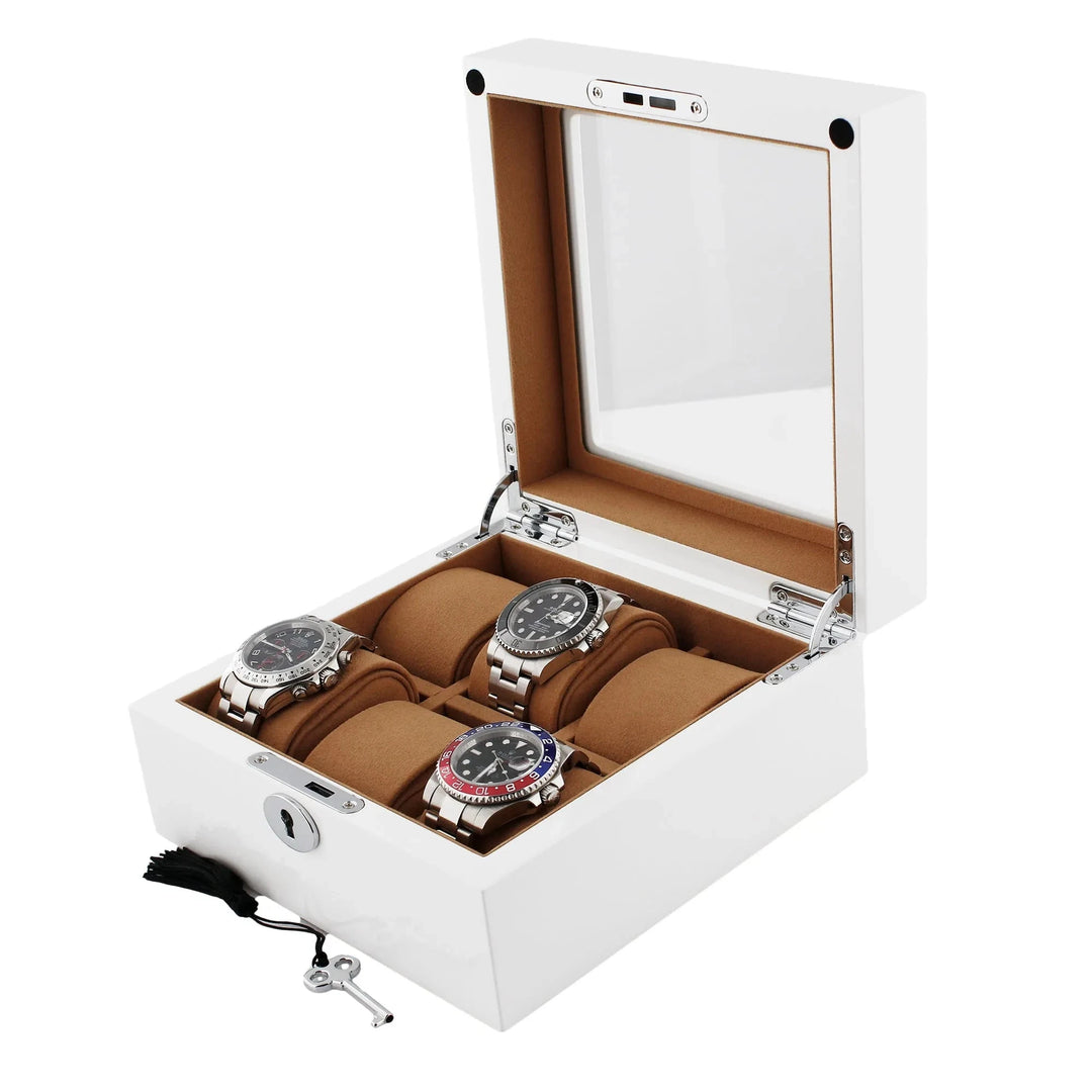 The 6 Watch Box in Luxurious White Wood with Camel Lining by Aevitas showcases up to six watches on brown cushions under a glass lid, with a small key and tassel beside the open box. One cushion is empty inside the tan interior.
