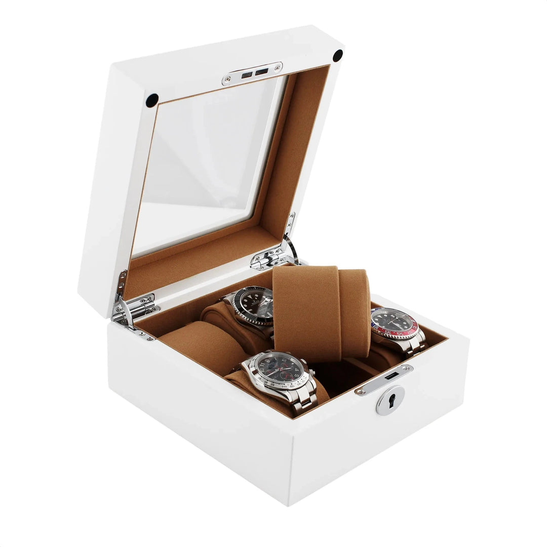 The Aevitas 6 Watch Box features luxurious white wood with a glossy finish, a glass lid, camel lining, and space for six watches. It includes brown cushions and a keyhole on the front for added security.
