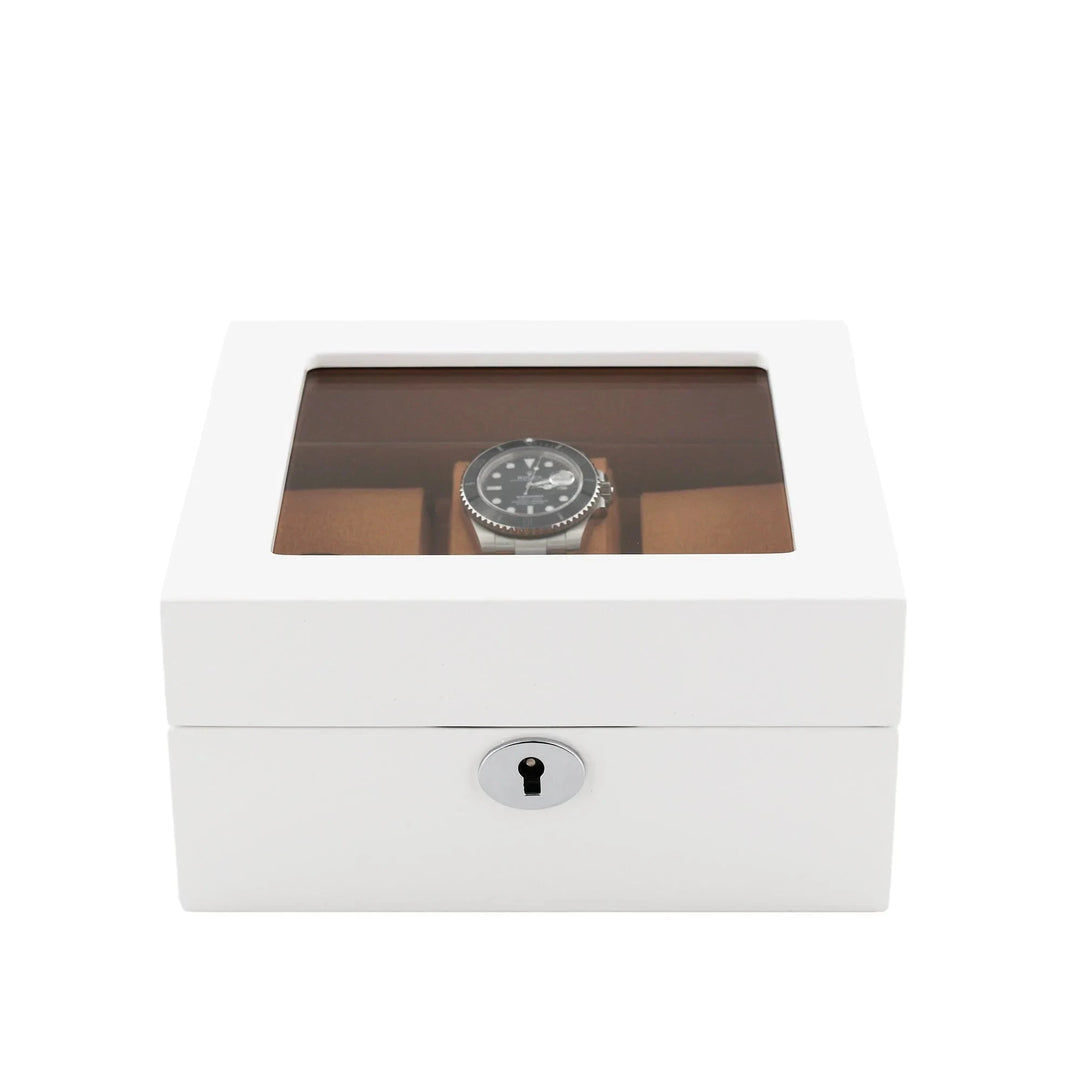 The Aevitas 6 Watch Box in Luxurious White Wood with Camel Lining features a transparent top to display your timepieces and a silver keyhole at the front for secure locking.