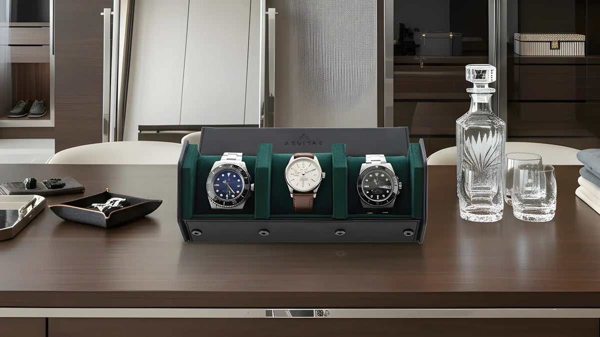 Watch Roll Case with three watches in a display case on a table with a modern bedroom in the background