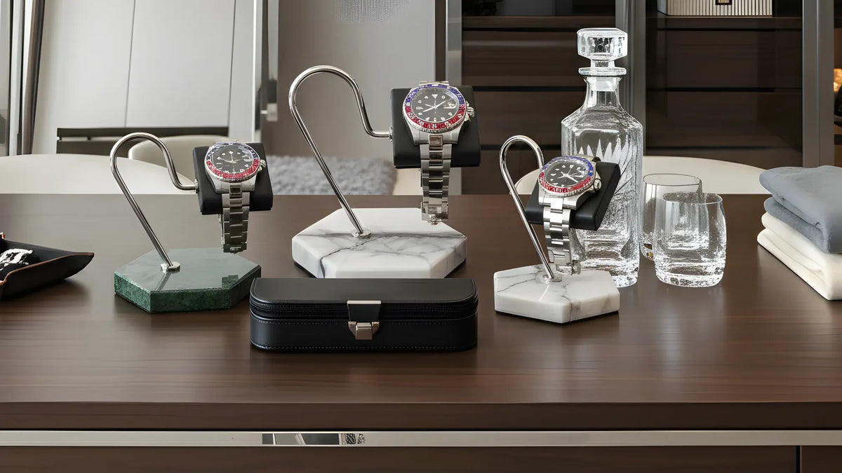 Collection of watches on stands and a decanter on a wooden surface.