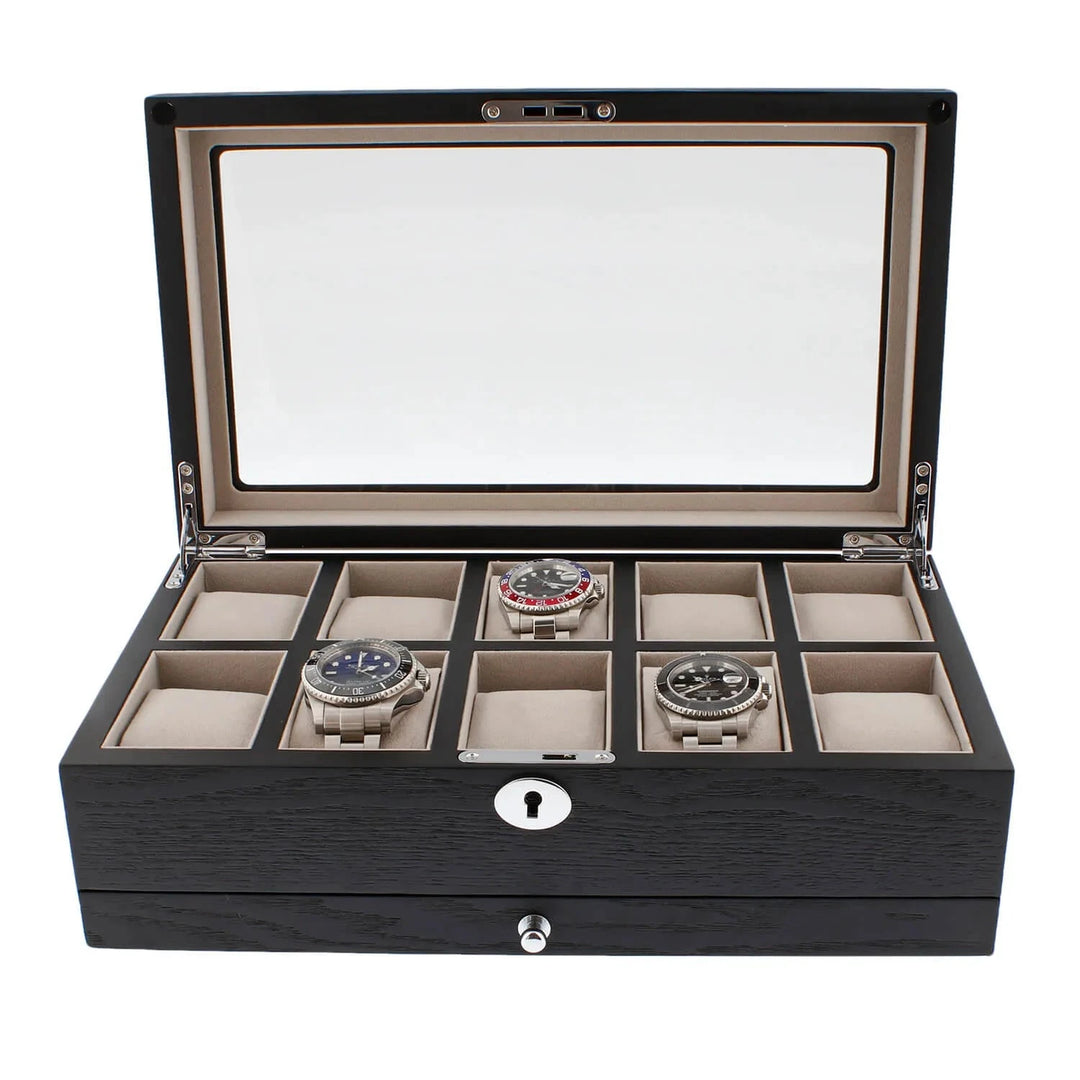 The Aevitas Black Oak Veneer Watch Box holds 10 watches, features a glass lid, keyhole front, extra storage drawer, and plush beige lining—an elegant premium-quality collector's case.