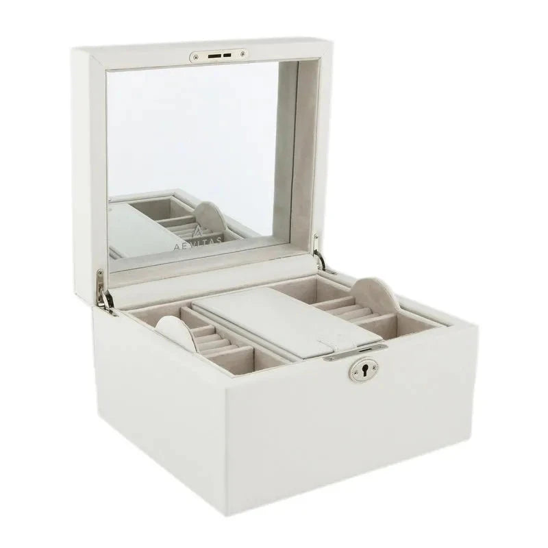 The Aevitas Large Size Ivory Bonded Leather Jewellery Box features a built-in mirror in the lid, multiple compartments for organizing jewellery, and a front lock. The box is open, displaying its neatly arranged interior.