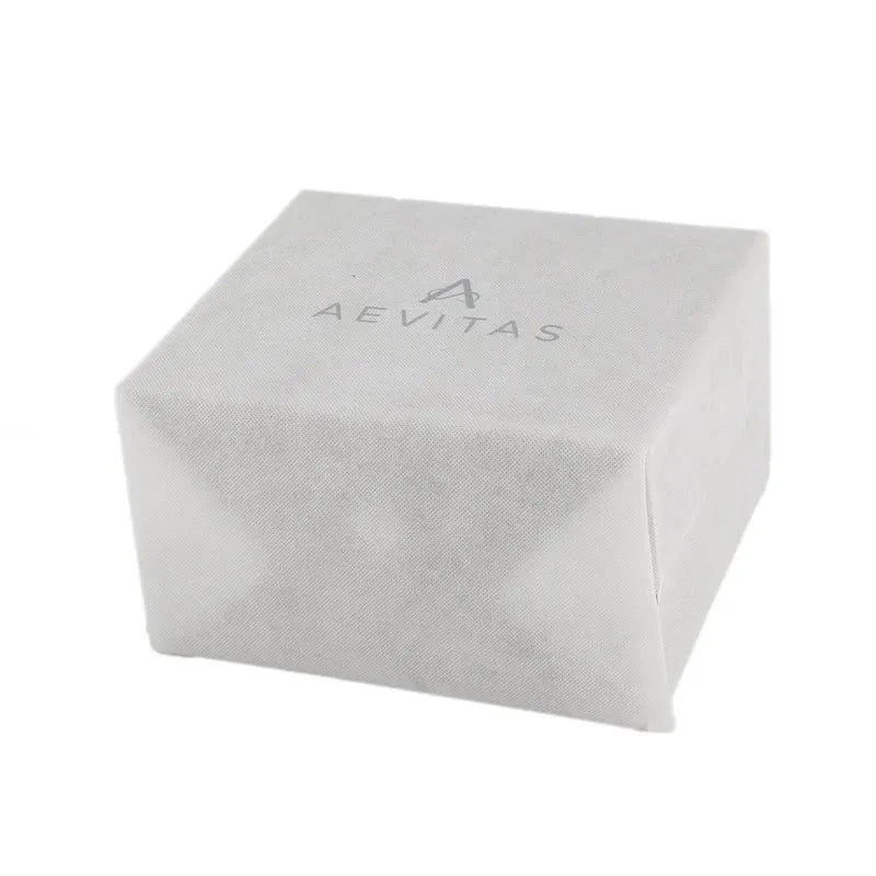 The Large Size Ivory Bonded Leather Jewellery Box by Aevitas features a square shape, soft fabric-like texture, and displays the AEVITAS name with a stylized A logo on top for an elegant, luxurious touch.