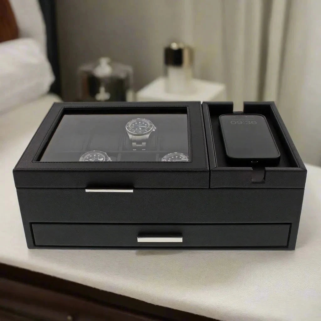 The Men's Large Black Valet Tray with 8 Watch Holders by Aevitas features a glass lid and a compartment for your smartphone, offering an elegant bedside organizer for displaying watches and storing essentials.