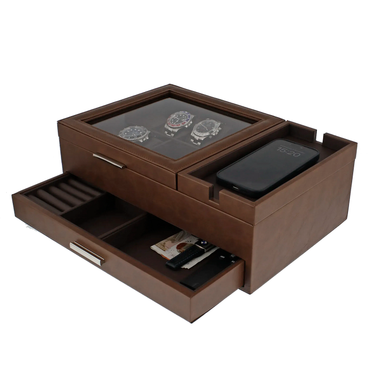 The Aevitas Men's Large Brown Valet Tray features 8 watch holders, compartments for small items, space for a phone, and an open drawer for your wallet, pen, and keys. Glass lid design by Aevitas keeps everything organized in style.