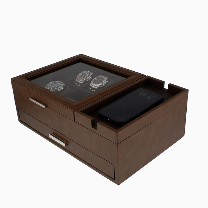 The Aevitas Men's Large Brown Valet Tray features 8 watch holders, two drawers, a glass lid displaying three watches, and a groove on the right for a smartphone.