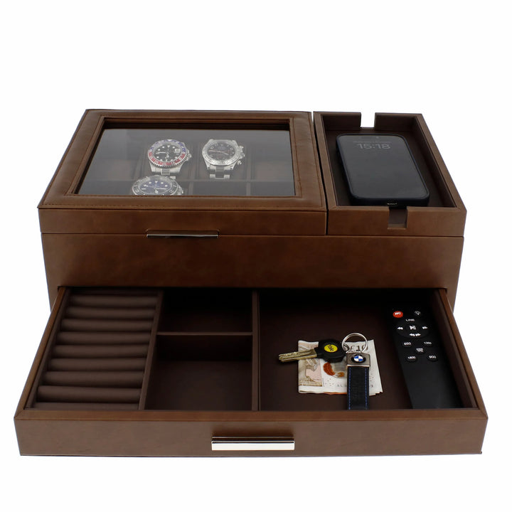 The Aevitas Men's Large Brown Valet Tray features 8 watch holders, a glass top, a slot for your smartphone, and an open drawer for keys, coins, money, and essentials—crafted from vegan leather for stylish organisation.