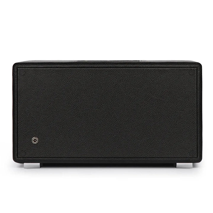 A black rectangular speaker with a textured front, silver feet, and a lower-left input sits on a white background—ideal for display alongside your Aevitas Premium Triple Watch Winder Black Genuine Leather Mains Powered.