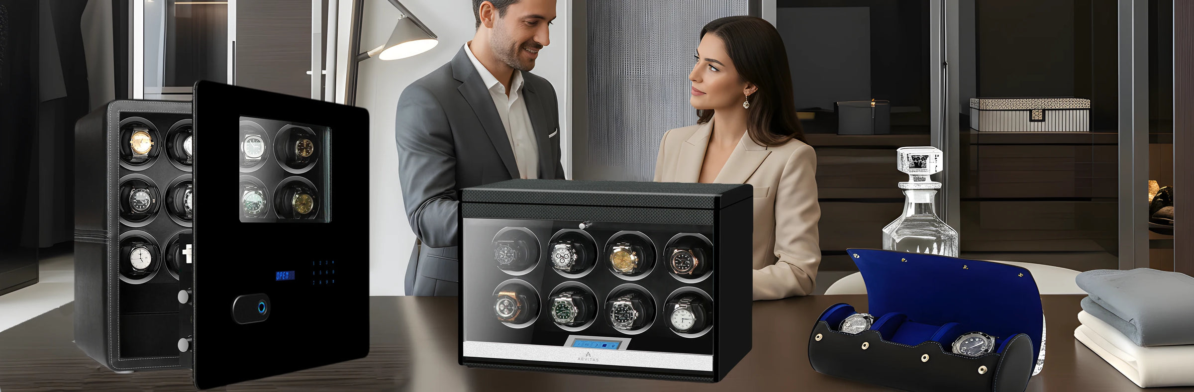 Watches in display cases and watch winder with a man and woman in the background